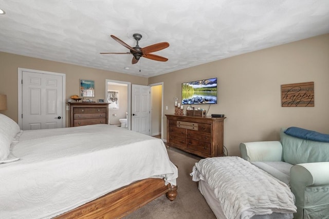 bedroom with ceiling fan, ensuite bathroom, and carpet flooring