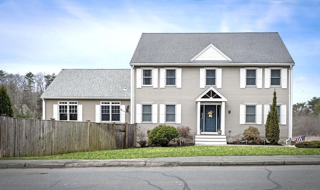 colonial house featuring fence