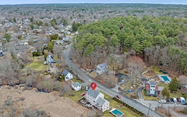 birds eye view of property with a view of trees