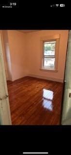 empty room with wood-type flooring