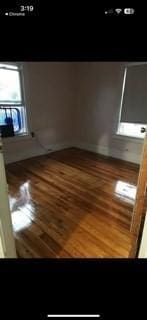 empty room with hardwood / wood-style flooring