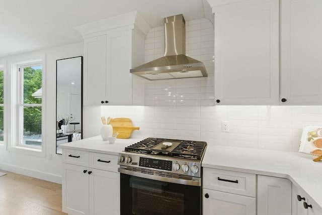 43-45 Wellington St Unit 2, Waltham, MA 02451 - kitchen with stainless steel gas range oven, wall chimney exhaust hood, white cabinets, and light countertops