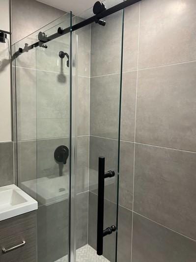 full bathroom featuring a shower stall and vanity