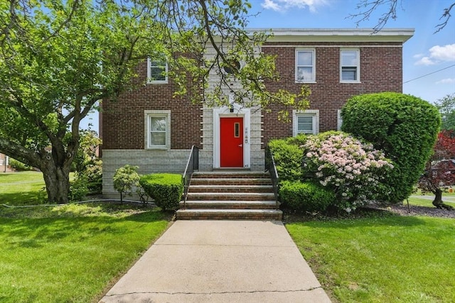 42 Newman Rd Unit 3, Malden, MA 02148 - view of front facade featuring brick siding and a front yard