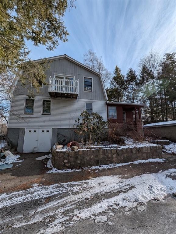 view of front of home with a garage and a balcony