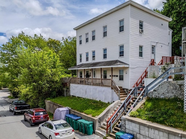 view of front of property with stairs and covered porch