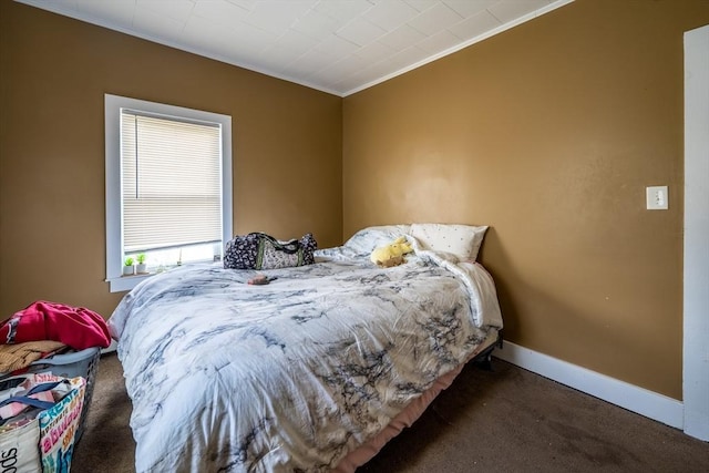 carpeted bedroom featuring ornamental molding and baseboards