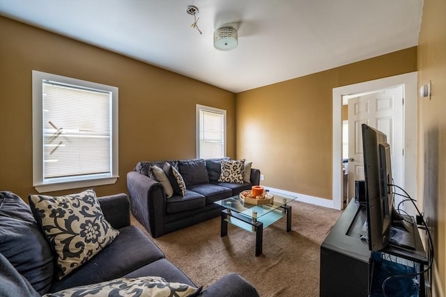 carpeted living area with baseboards