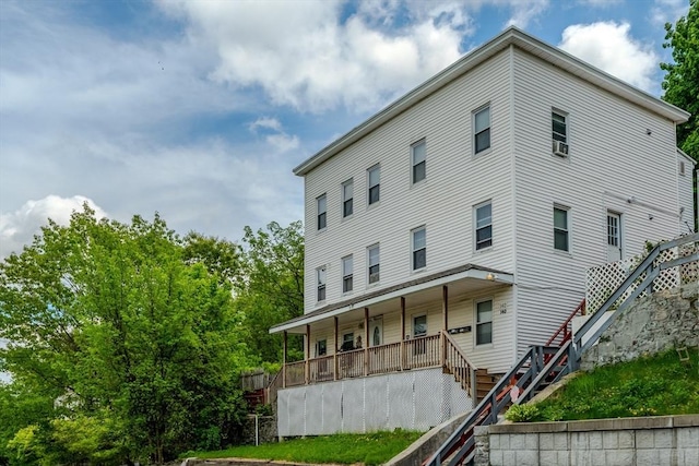 view of front of house featuring stairway and a porch