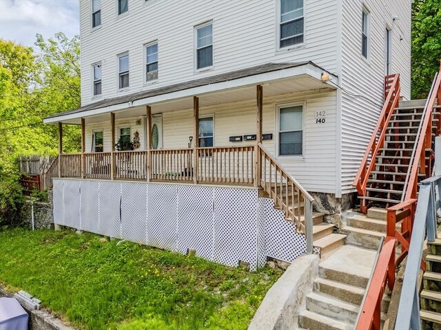 view of front of property featuring stairway and covered porch