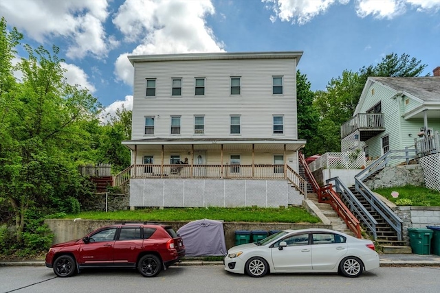 townhome / multi-family property featuring stairs and a porch