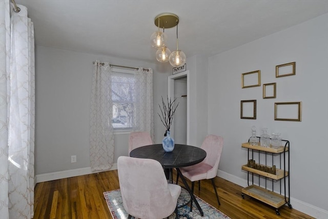 dining space with wood finished floors and baseboards