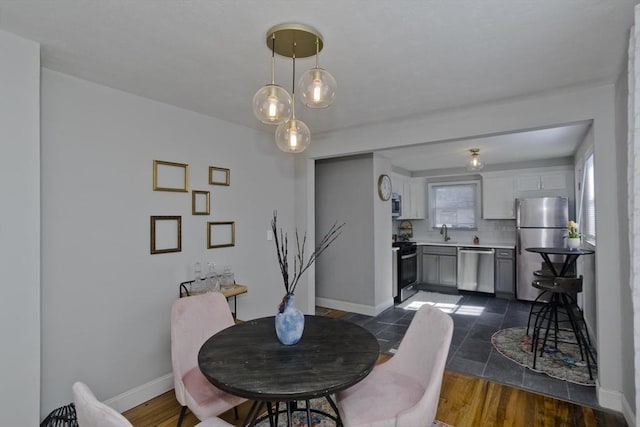 dining room with baseboards and dark wood-type flooring