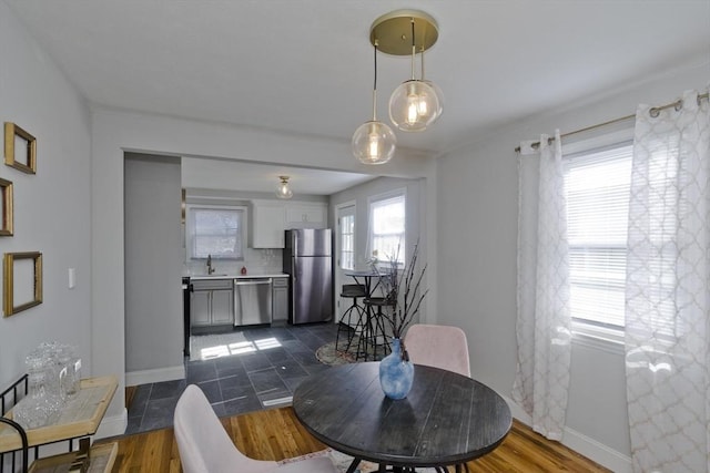 dining area featuring baseboards and dark wood finished floors