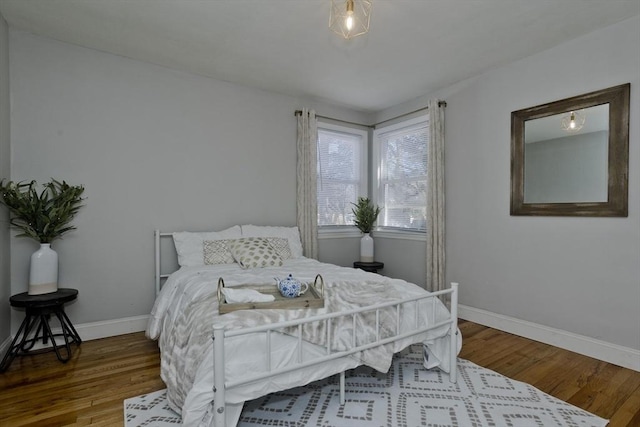 bedroom with wood finished floors and baseboards