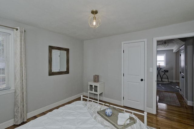 bedroom featuring baseboards and wood finished floors