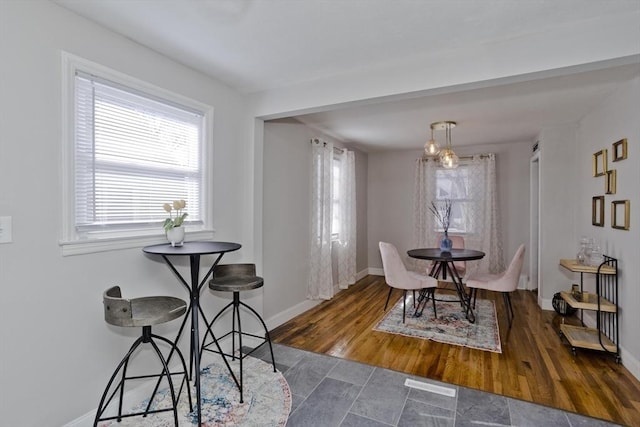 dining area featuring wood finished floors and baseboards