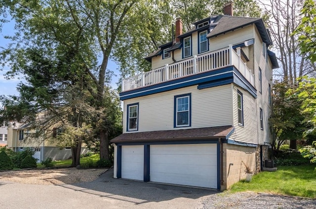 409-411 Atlantic Ave Unit 409, Marblehead, MA 01945 - view of front of property with a balcony, an attached garage, a chimney, and a shingled roof