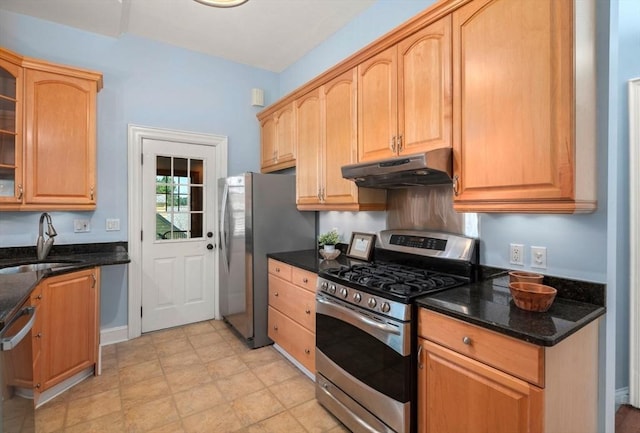 409-411 Atlantic Ave Unit 409, Marblehead, MA 01945 - kitchen featuring under cabinet range hood, stainless steel appliances, glass insert cabinets, and dark stone counters