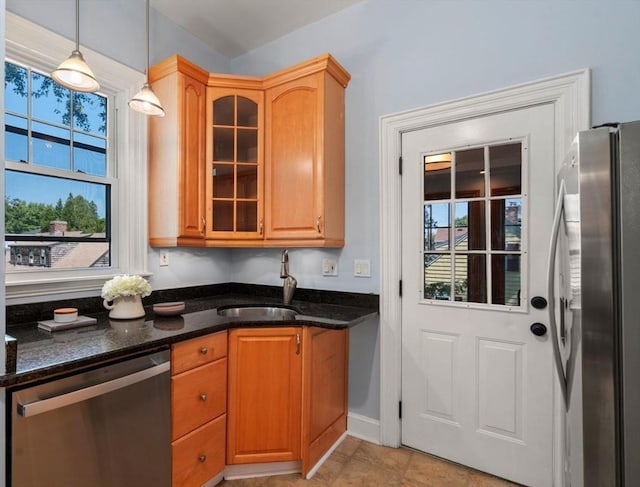 409-411 Atlantic Ave Unit 409, Marblehead, MA 01945 - kitchen featuring stainless steel appliances, glass insert cabinets, dark stone countertops, and pendant lighting