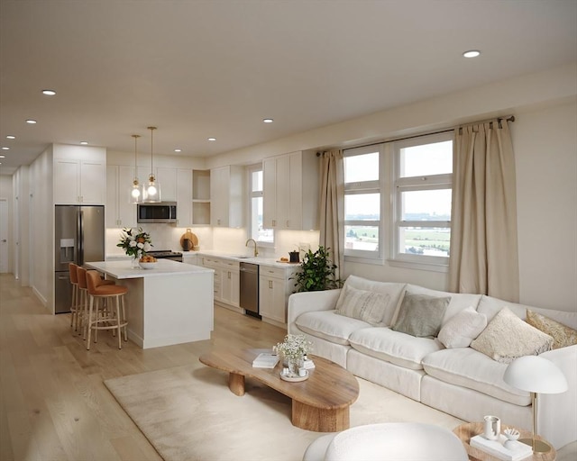 living room with recessed lighting and light wood finished floors