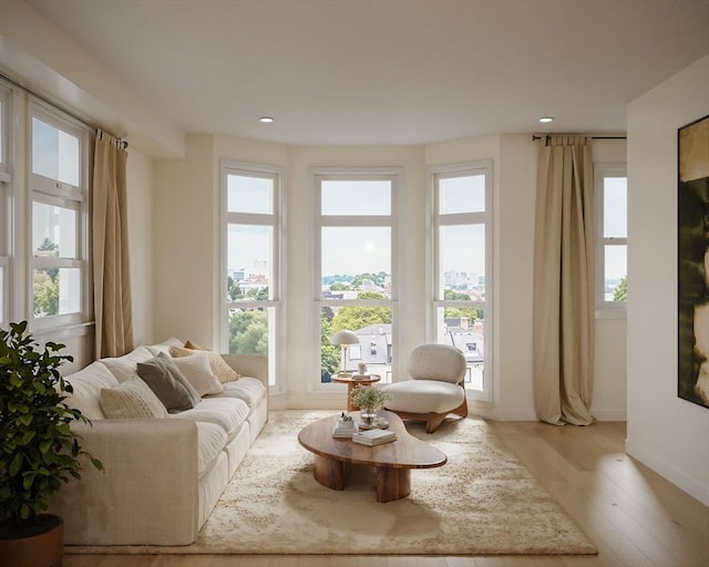 living area with recessed lighting, light wood-style floors, and baseboards