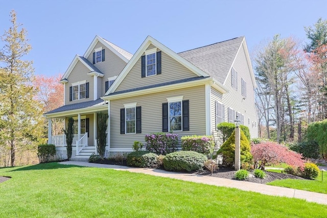 view of front of property with a porch and a front lawn