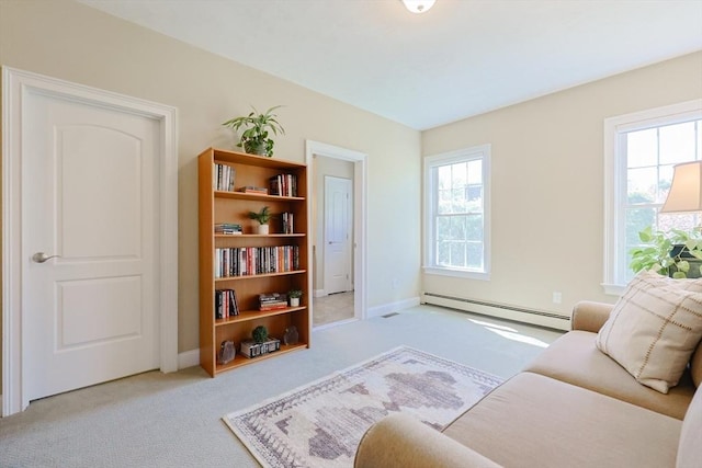 sitting room featuring baseboards, carpet flooring, and baseboard heating