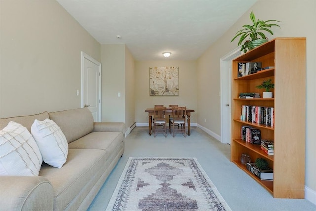 living area with baseboards, light colored carpet, and baseboard heating