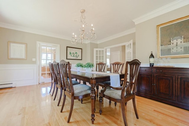 dining space with light wood-style floors, crown molding, a notable chandelier, and baseboard heating