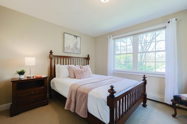 bedroom featuring baseboards and light colored carpet