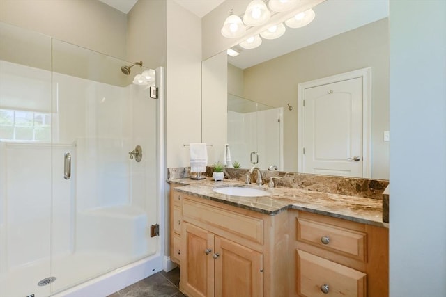 bathroom featuring vanity, tile patterned floors, and a stall shower