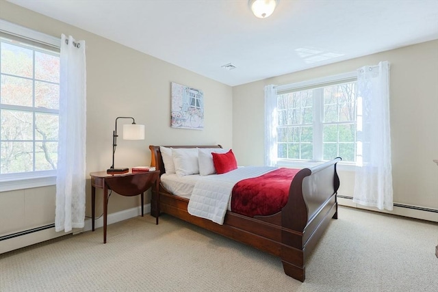 carpeted bedroom with baseboards, visible vents, and multiple windows