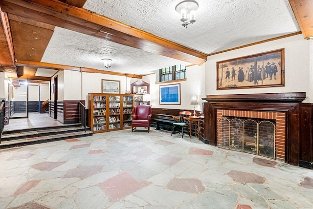 50 Follen St Unit 306, Cambridge, MA 02138 - sitting room featuring stone floors, a textured ceiling, and a brick fireplace