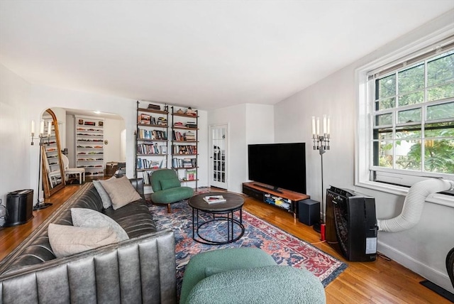 50 Follen St Unit 306, Cambridge, MA 02138 - living area with wood finished floors and arched walkways