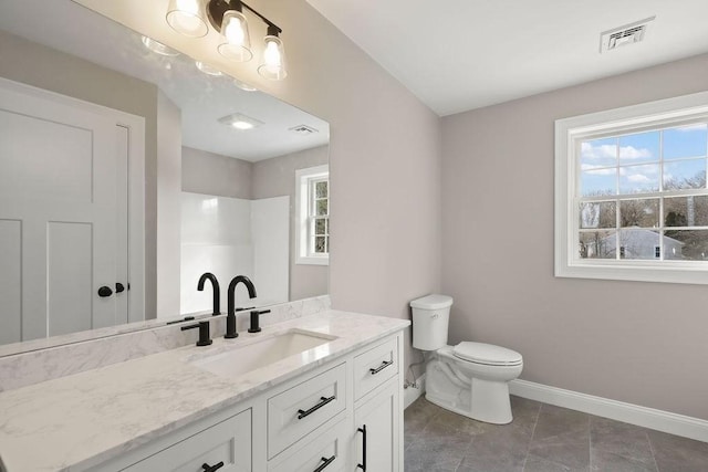 bathroom featuring tile patterned flooring, vanity, and toilet