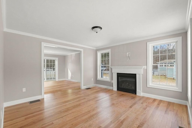 unfurnished living room featuring crown molding and light hardwood / wood-style flooring