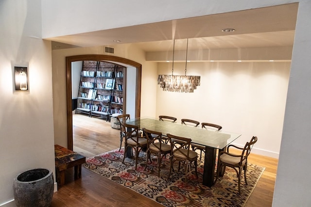 261-263 Main St, Northampton, MA 01060 - dining area featuring wood-type flooring, lofted ceiling, and a notable chandelier
