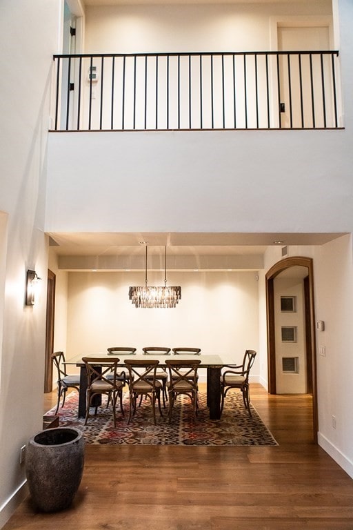 261-263 Main St, Northampton, MA 01060 - dining room with wood-type flooring, a towering ceiling, and an inviting chandelier