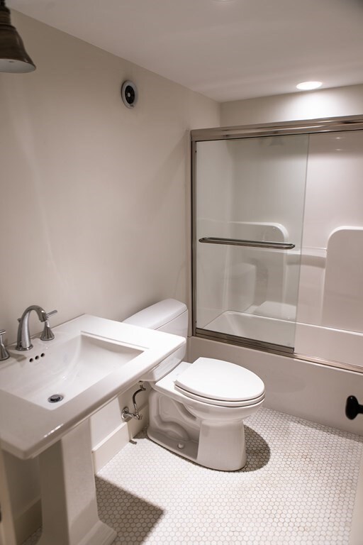 261-263 Main St, Northampton, MA 01060 - full bathroom featuring tile flooring, sink, toilet, and bath / shower combo with glass door