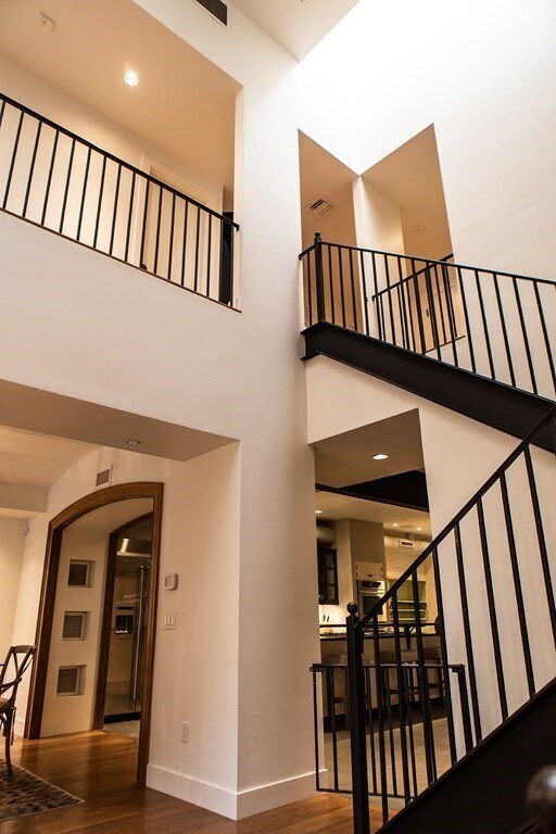 261-263 Main St, Northampton, MA 01060 - staircase featuring hardwood / wood-style floors and a towering ceiling