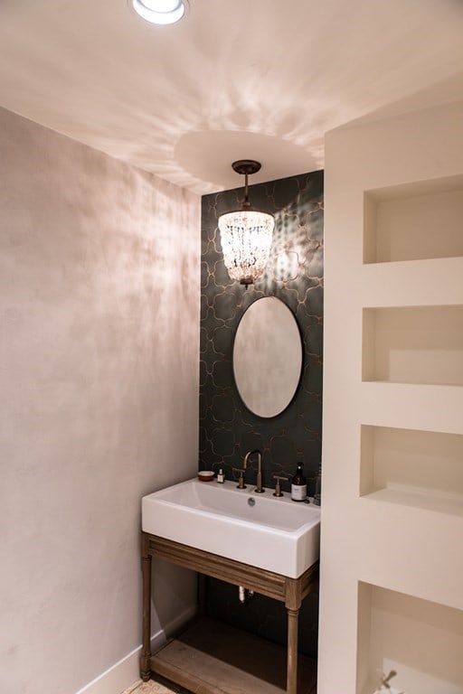 261-263 Main St, Northampton, MA 01060 - bathroom featuring built in features, a notable chandelier, and sink