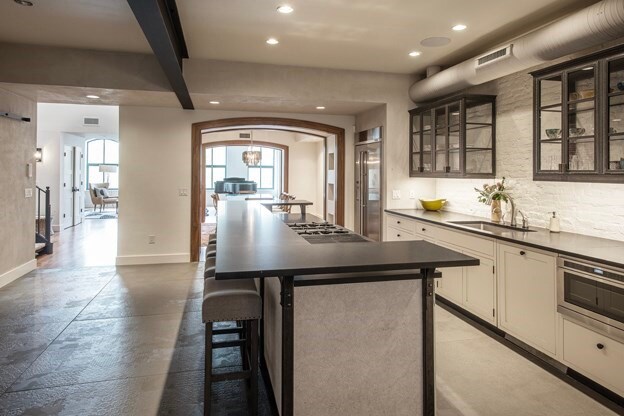 261-263 Main St, Northampton, MA 01060 - kitchen with a kitchen breakfast bar, white cabinets, stainless steel appliances, sink, and a kitchen island