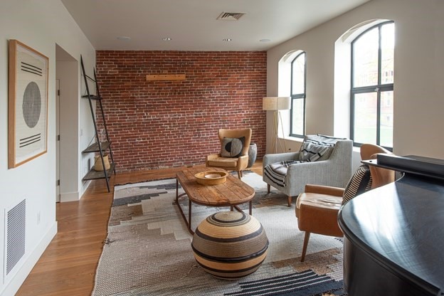 261-263 Main St, Northampton, MA 01060 - sitting room with hardwood / wood-style flooring and brick wall