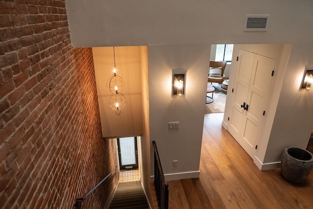 261-263 Main St, Northampton, MA 01060 - stairway with hardwood / wood-style floors and brick wall