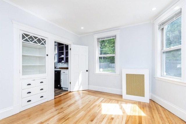 221 Eastern Ave, Lynn, MA 01902 - unfurnished bedroom featuring light wood-style flooring, radiator, baseboards, and crown molding