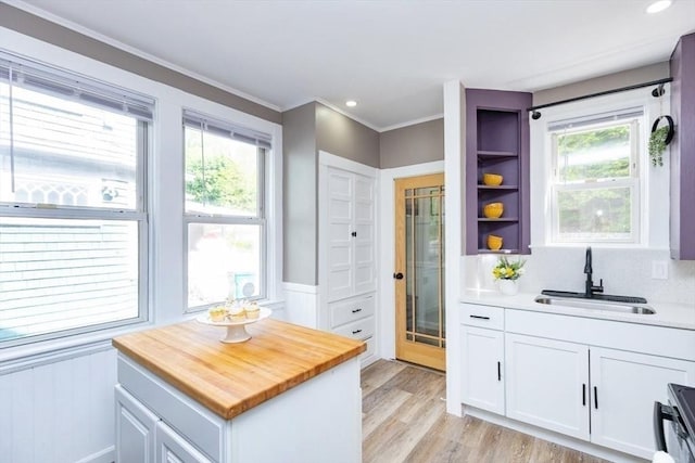 221 Eastern Ave, Lynn, MA 01902 - kitchen with a sink, wood counters, white cabinetry, stove, and healthy amount of natural light