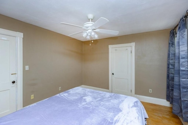221 Eastern Ave, Lynn, MA 01902 - bedroom with baseboards, wood finished floors, and ceiling fan