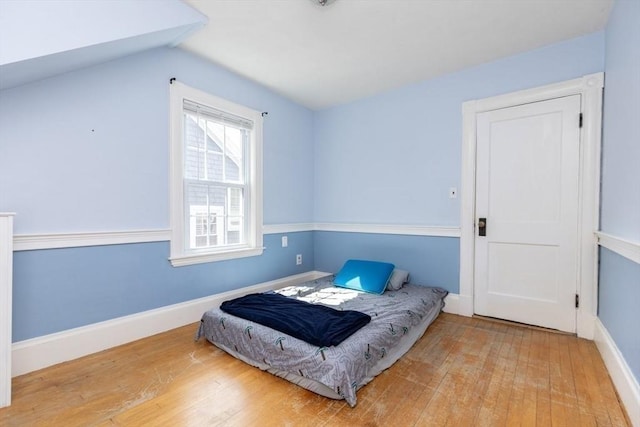 221 Eastern Ave, Lynn, MA 01902 - bedroom featuring wood finished floors, lofted ceiling, and baseboards