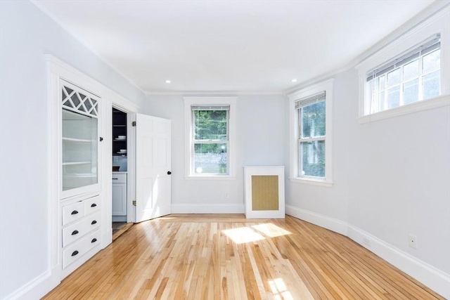 221 Eastern Ave, Lynn, MA 01902 - unfurnished bedroom featuring light wood-style flooring, multiple windows, and baseboards